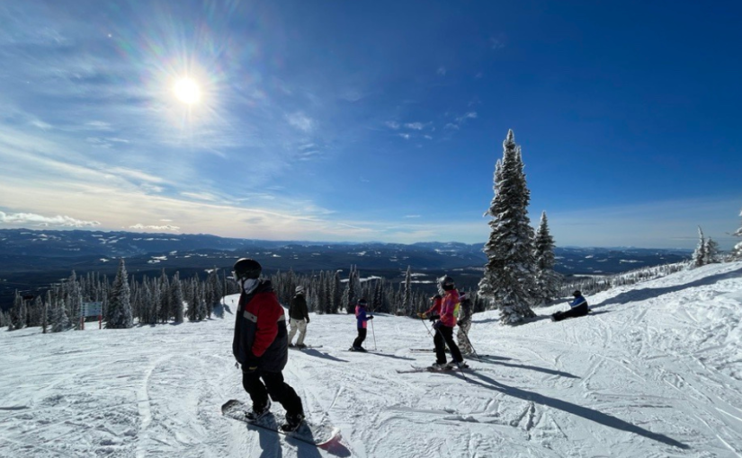 A group of people skiing on a snowy mountain - Dilworth Homes